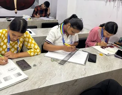 Students learning Fashion Designing in classroom